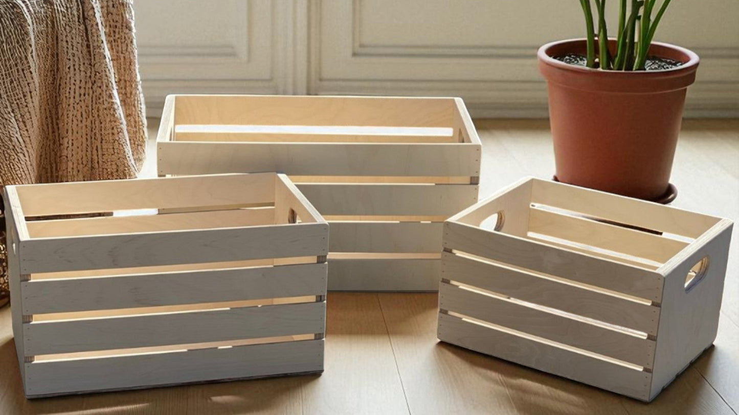 Set of wooden crates on a light wooden floor with a plant in the background.