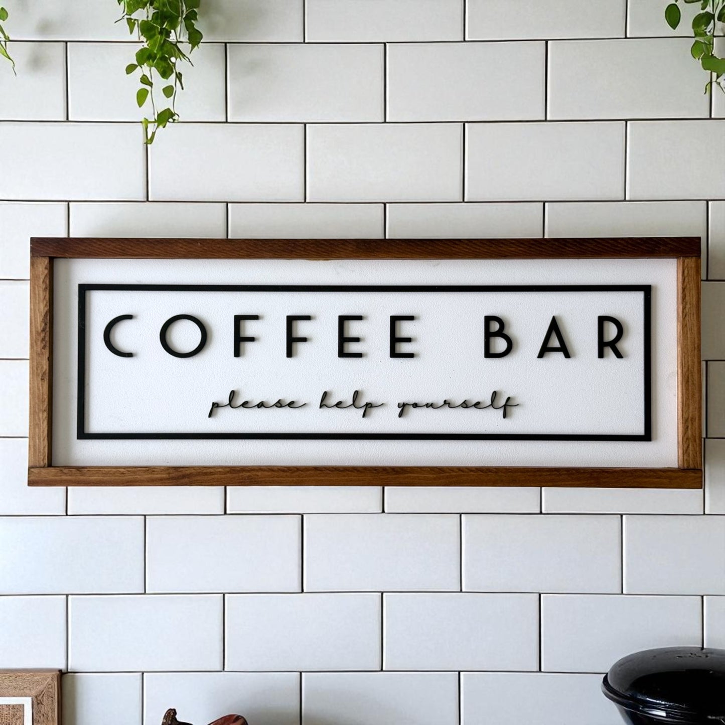 Wooden-framed 'COFFEE BAR please help yourself' sign on a tiled wall.
