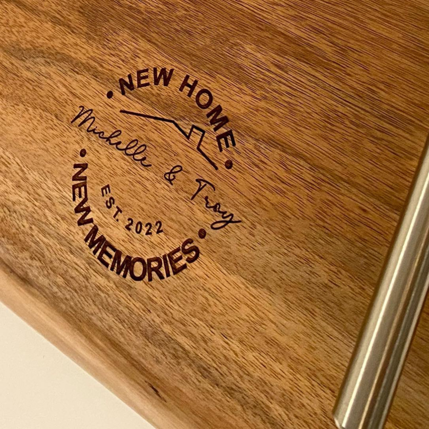 Wooden plaque with engraved text 'New Home Michelle & Troy EST. 2022 New Memories'