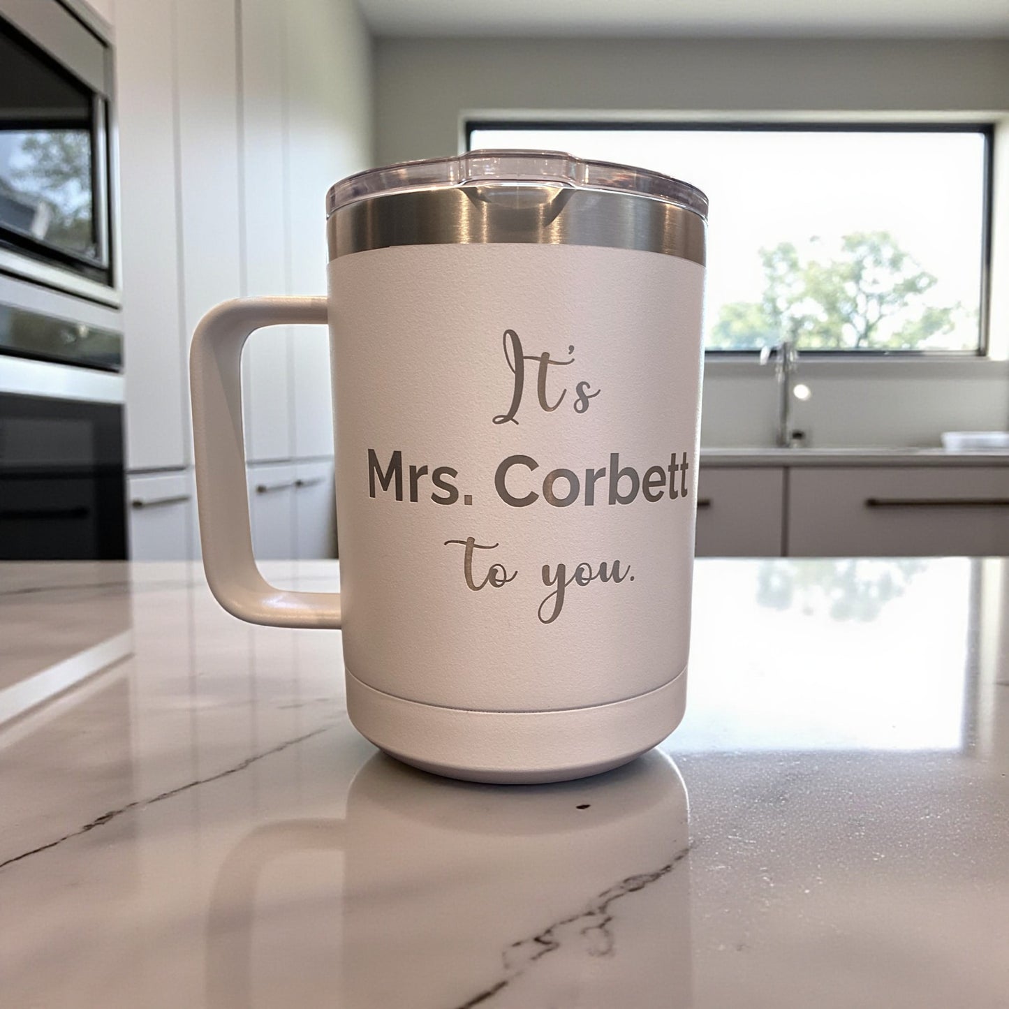 White mug with 'It's Mrs. Corbett to you.' text on a kitchen counter
