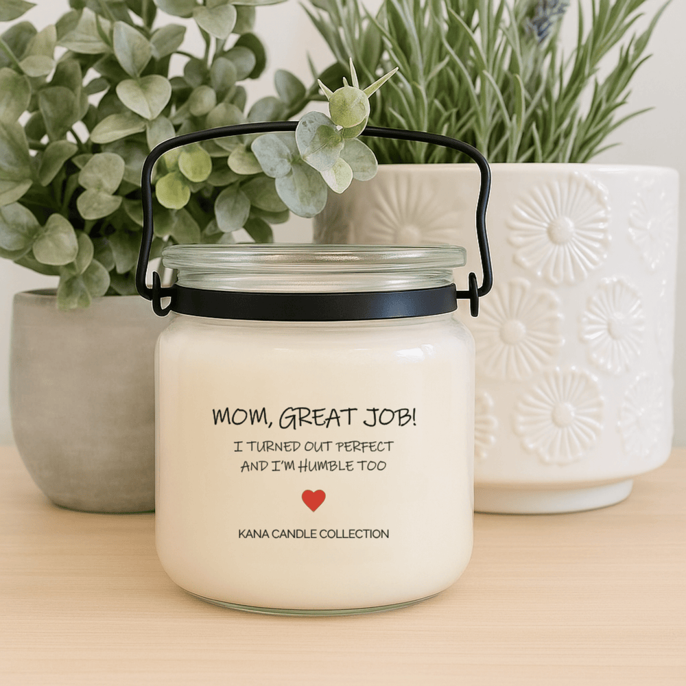 Mother’s Day soy candle in glass jar on a table with small planters and greenery with personalized label reading “Mom, Great Job. I Turned Out Perfect and I’m Humble Too”