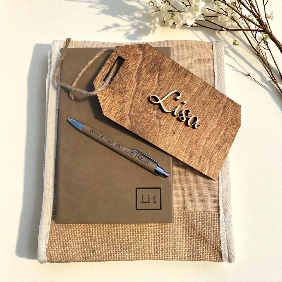 Notebook with pen and wooden tag on a light background