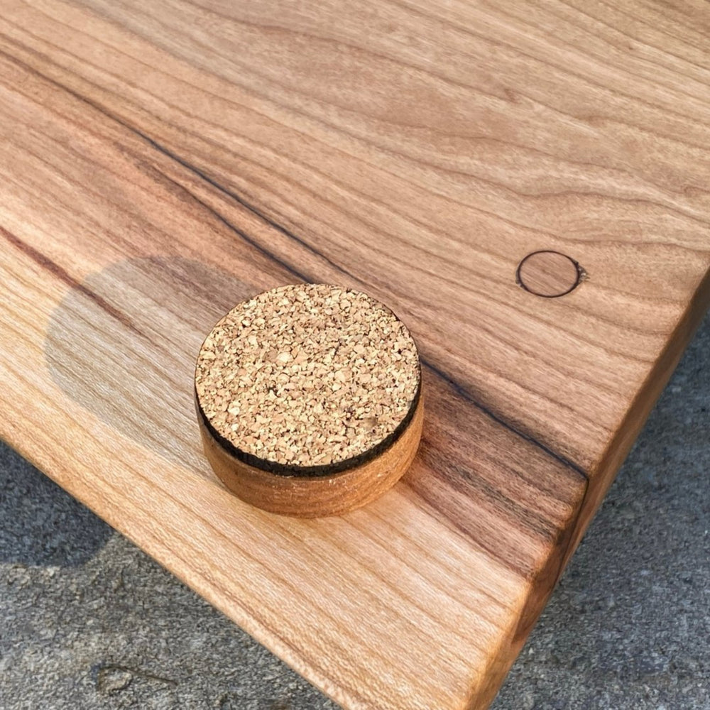 
                  
                    Backide of Cherry Live Edge Charcuterie Board showing close up of corked feet
                  
                