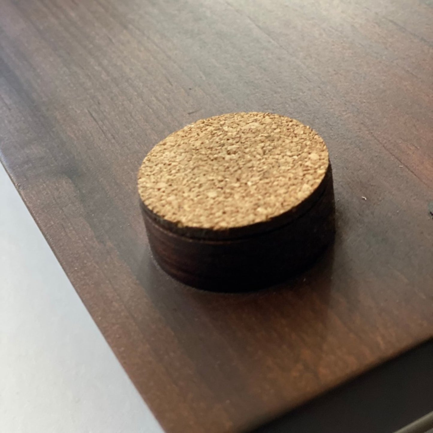 backside of roasted maple board showing round feet with cork protection