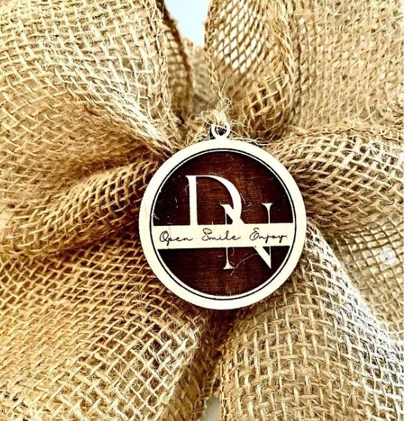 
                  
                    Personalized Baltic Birch Tag that is laser engraved and cut in a 2 x 2 circle with D N monogram initials
                  
                