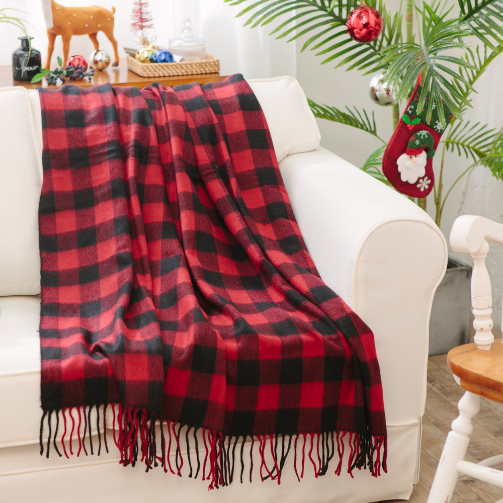 
                  
                    red and black buffalo plaid blanket drape over couch with seasonal decorations
                  
                