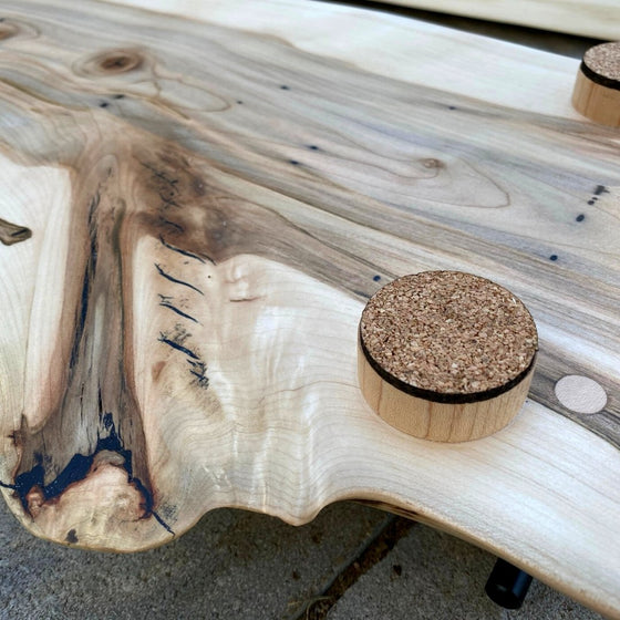 Back of maple board showing round wood feet with cork protection