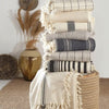 mixed throw options sitting on wicker basket with decor in background