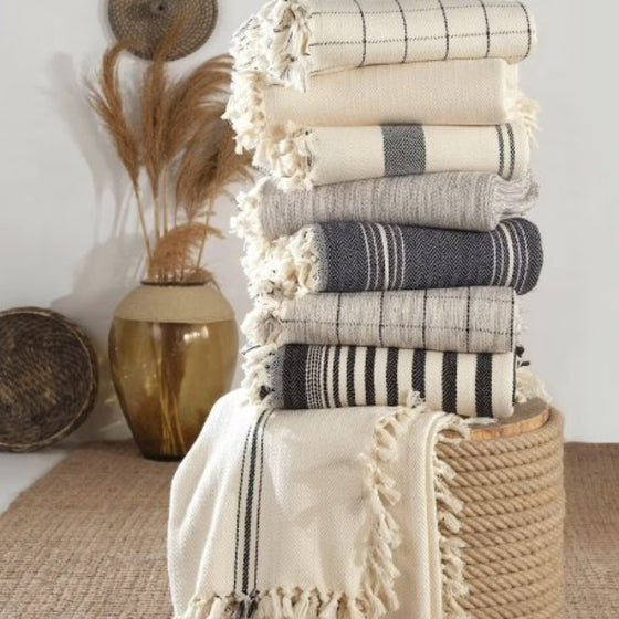 mixed throw options sitting on wicker basket with decor in background