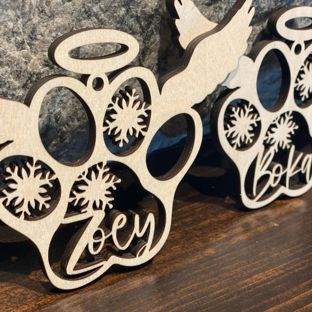 
                  
                    Baltic Birch Winged Paw Print Ornament with puppy name engraved in middle - The Red Door Engraving Company Inc.
                  
                